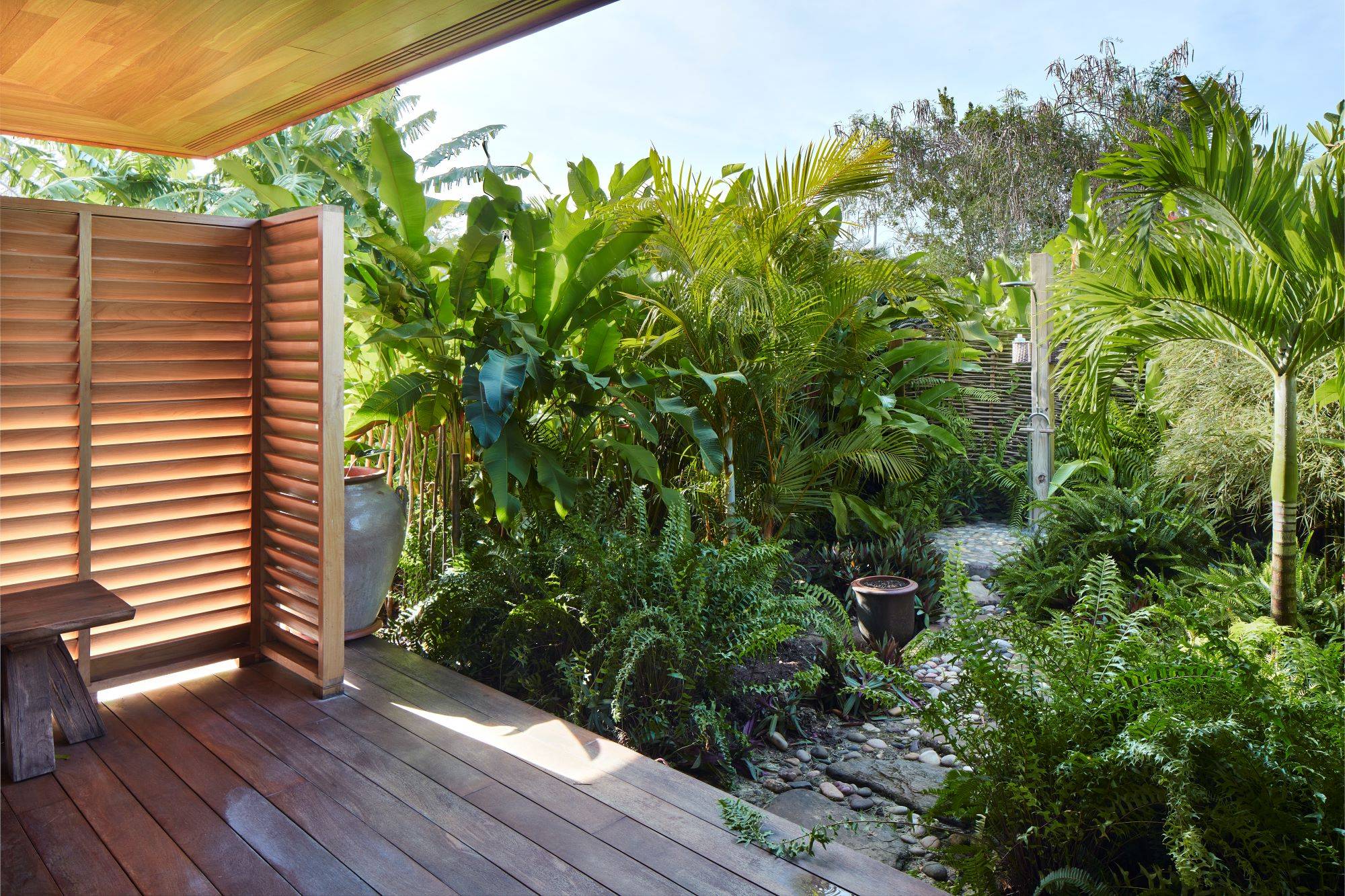 outdoor shower, outdoor bath, timber, wood, landscape, vegetation, palm trees, plants, trees, fieldstone, cobblestone, stone, deck